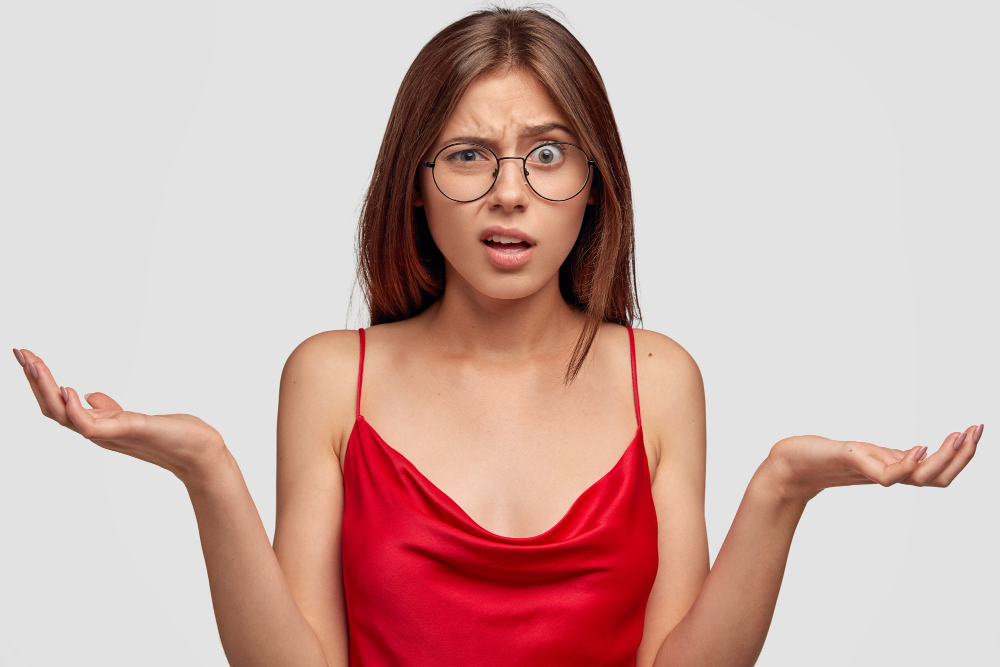 indignant-brunette-young-woman-posing-against-white-wall.jpg