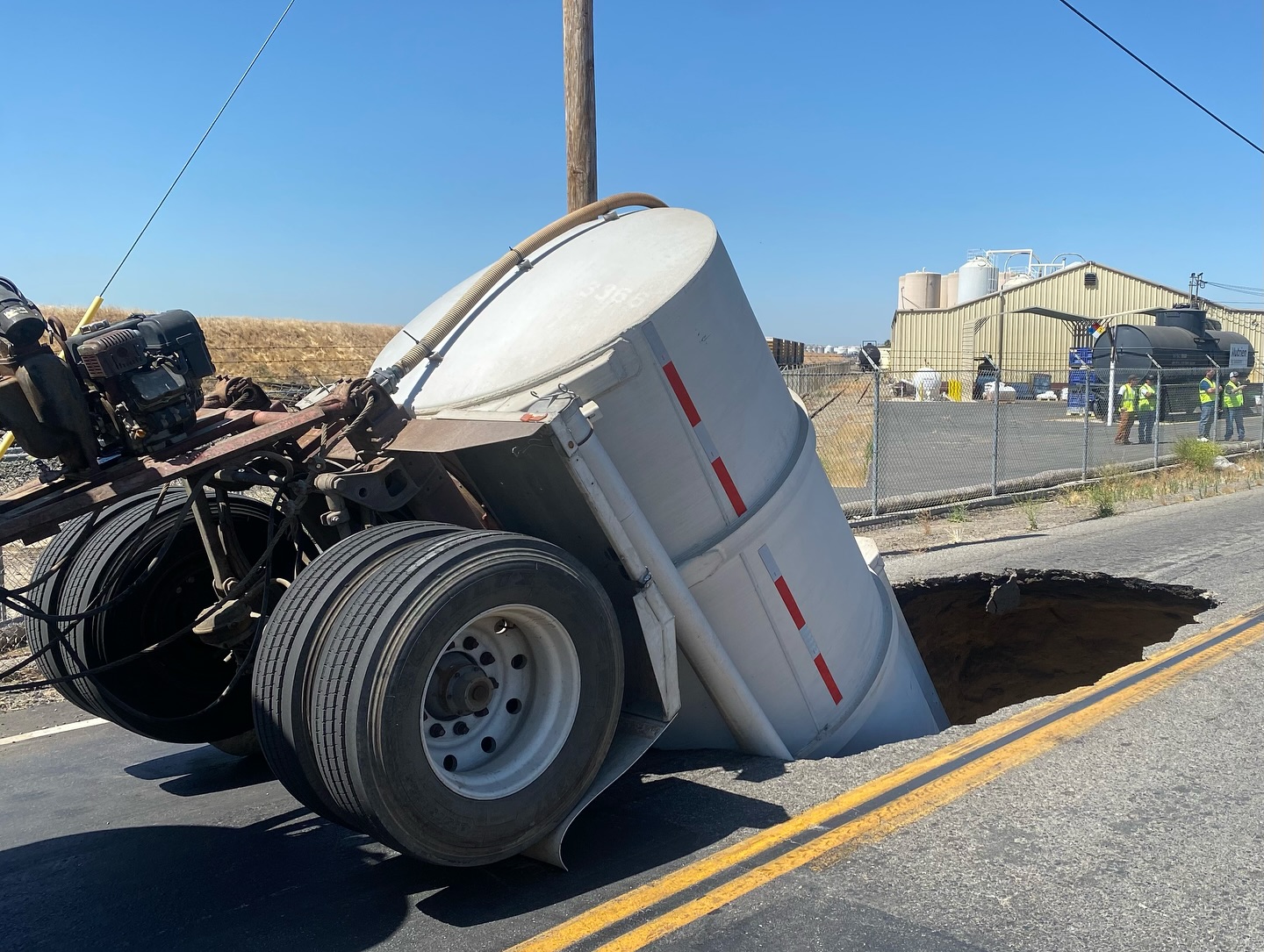 Shocking-images-show-truck-swallowed-by-sinkhole-as-road-collapses-4.jpg